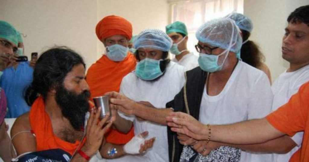 Old image of Baba Ramdev breaking fast shared as him getting knee surgery in Germany