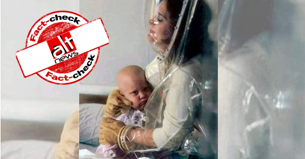 Photo from 1985 where mother in protective gear holds her baby given coronavirus spin